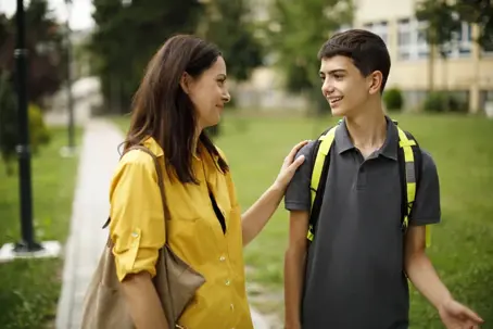 mother dropping off teen at school