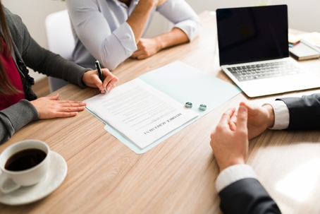 couple signing divorce papers in lawyer's office